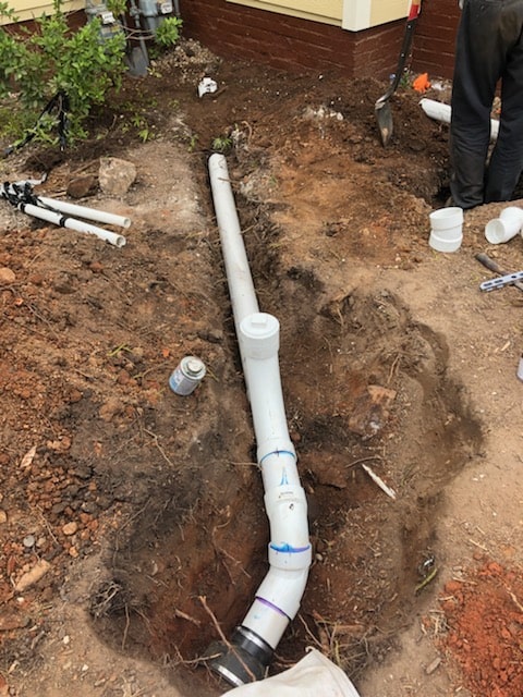 plumber repairing a broken sewer line pipe Clayton, NC