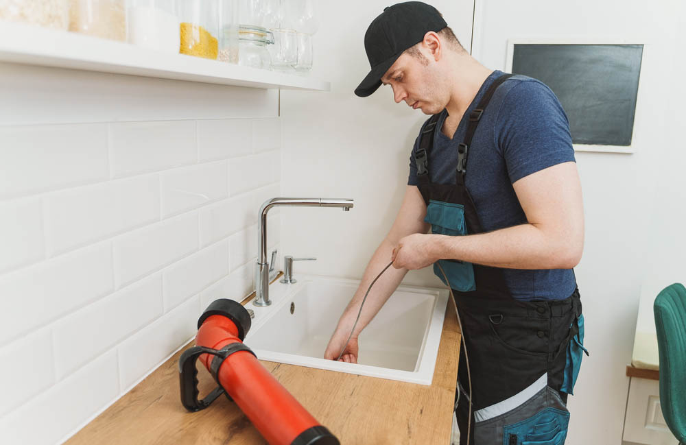 plumber cleaning clogged drain Clayton, NC